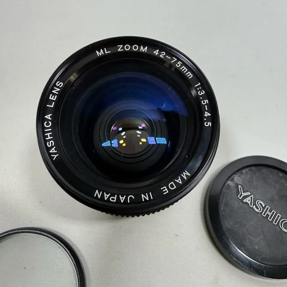 Yashica Zoom Lens 42- 75mm with case & Hakuba uv 55mm lens